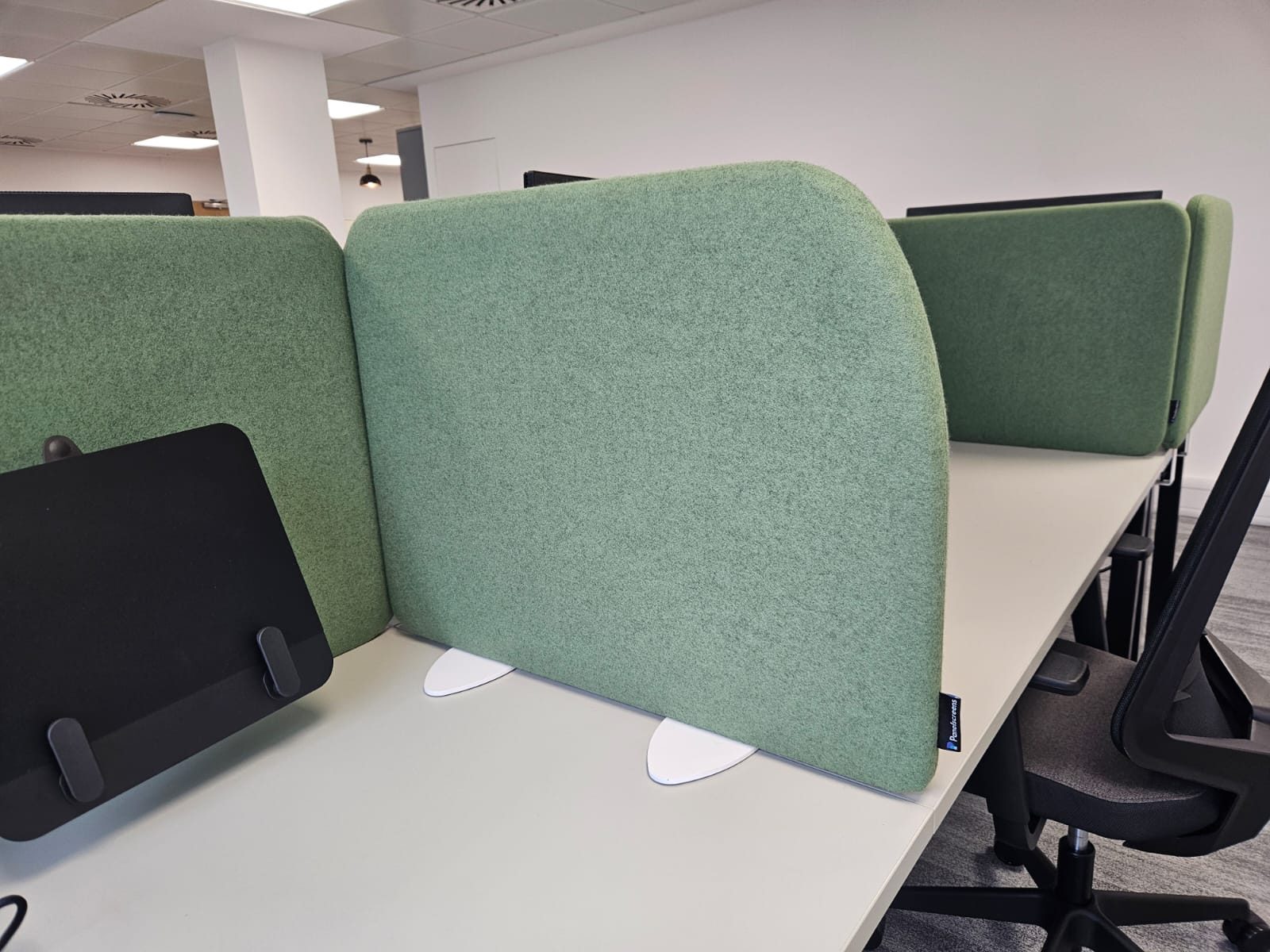 Hush 50 desk screen side panel on oval freestanding feet between bench desks at Totum Partners, London