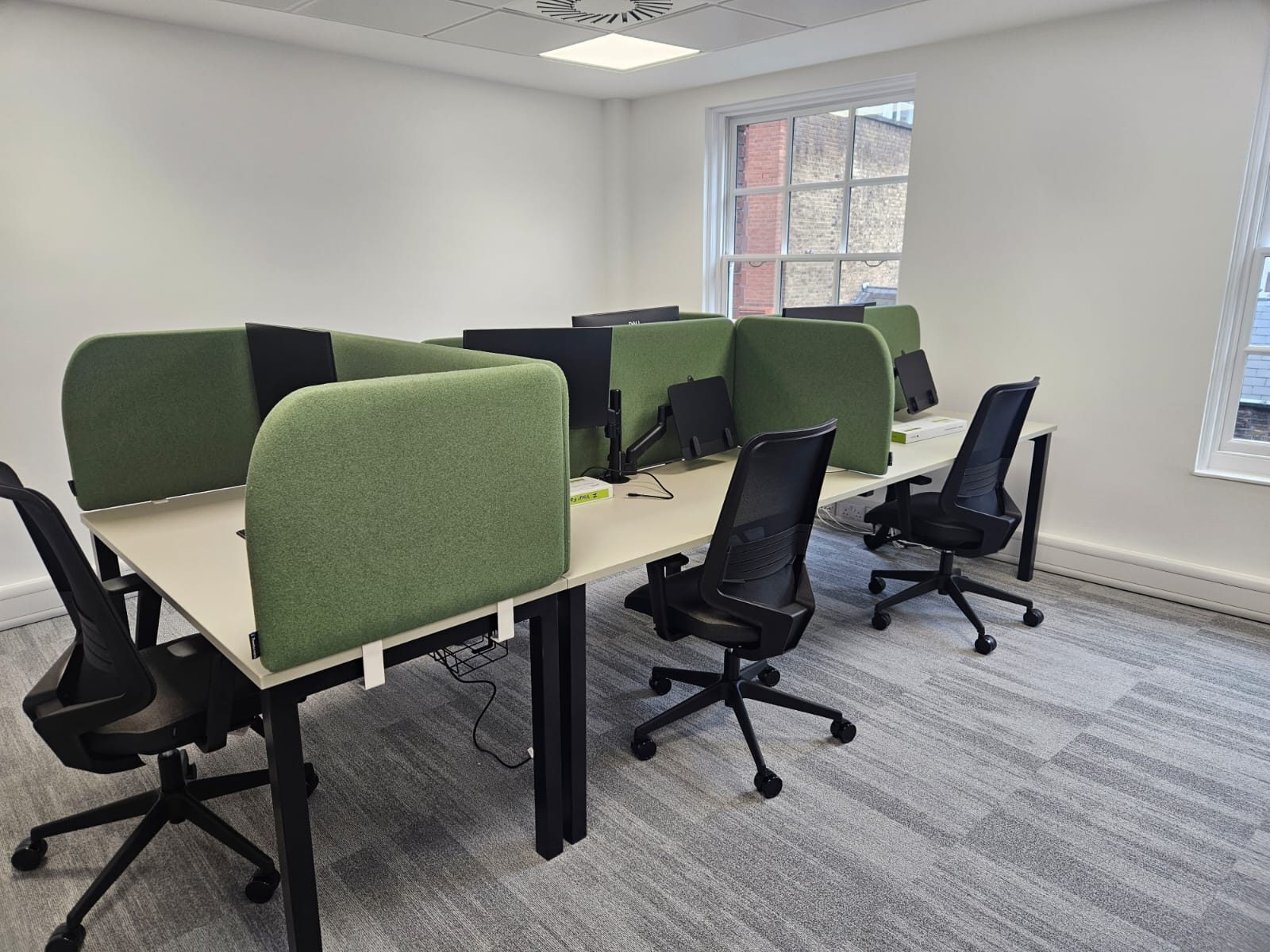 Moss green Hush 50 desk screens dividing bench desks into pods in a City of London office